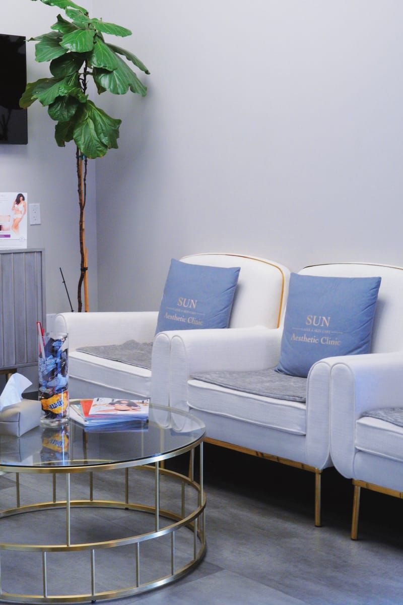 Waiting area with Sun Aesthetic Clinic branded pillows