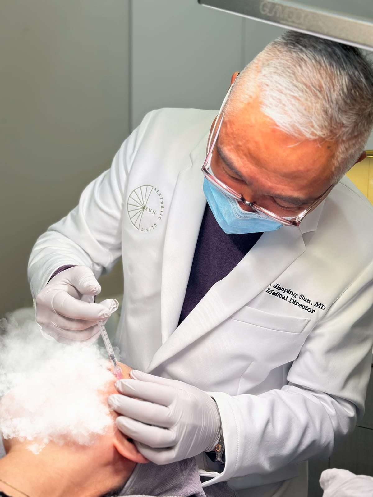 Dr. Jay Sun administering an injectable treatment at Sun Aesthetic Clinic